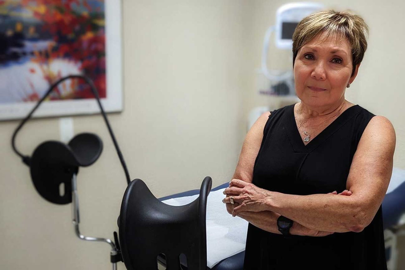 Renee Chelian standing in a doctor's office