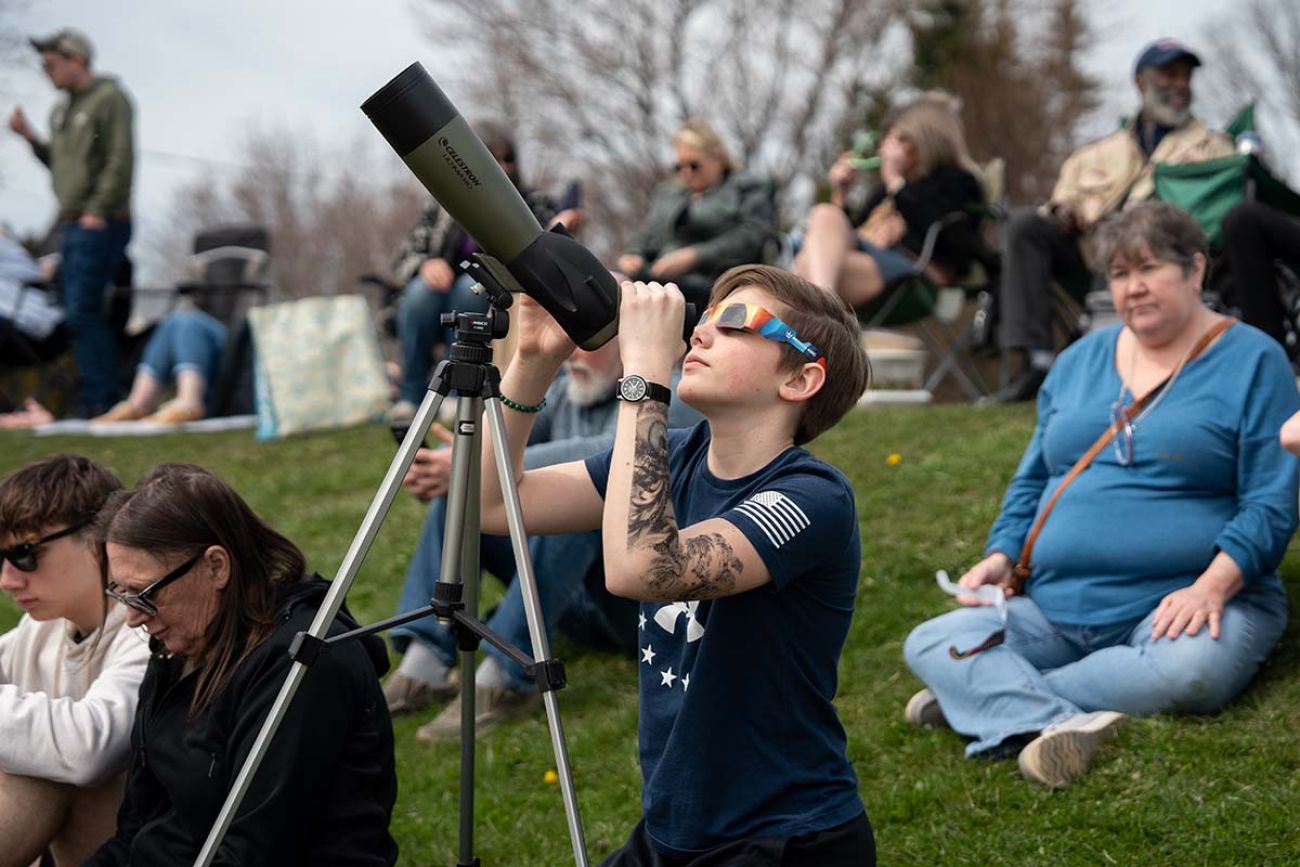person holds telescope