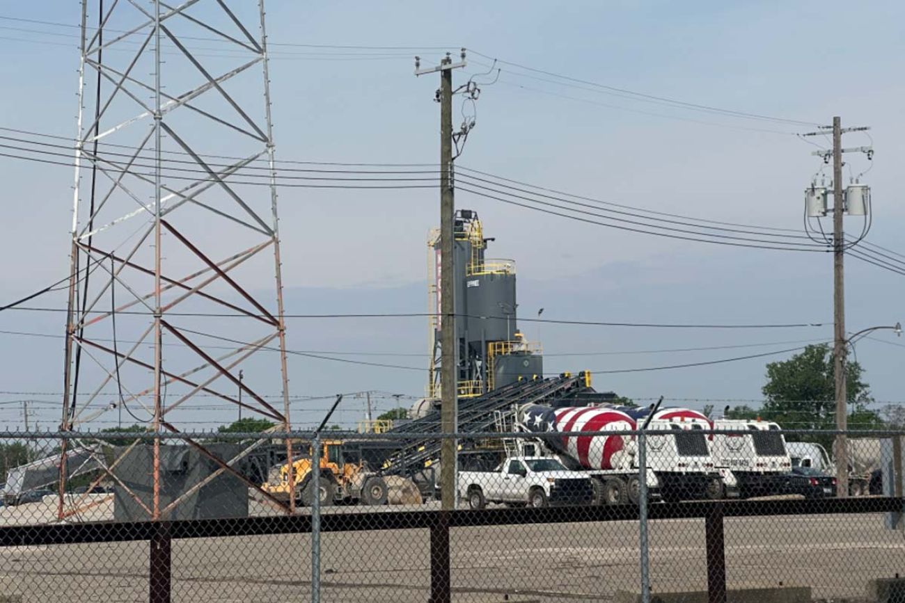 Several trucks parked in front of a plant