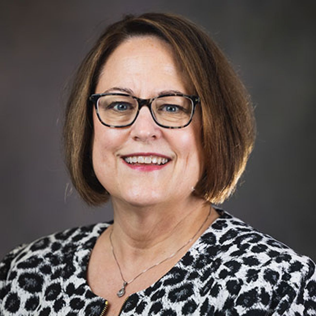 Jennifer DeHaemers headshot. She is wearing a black and white shirt