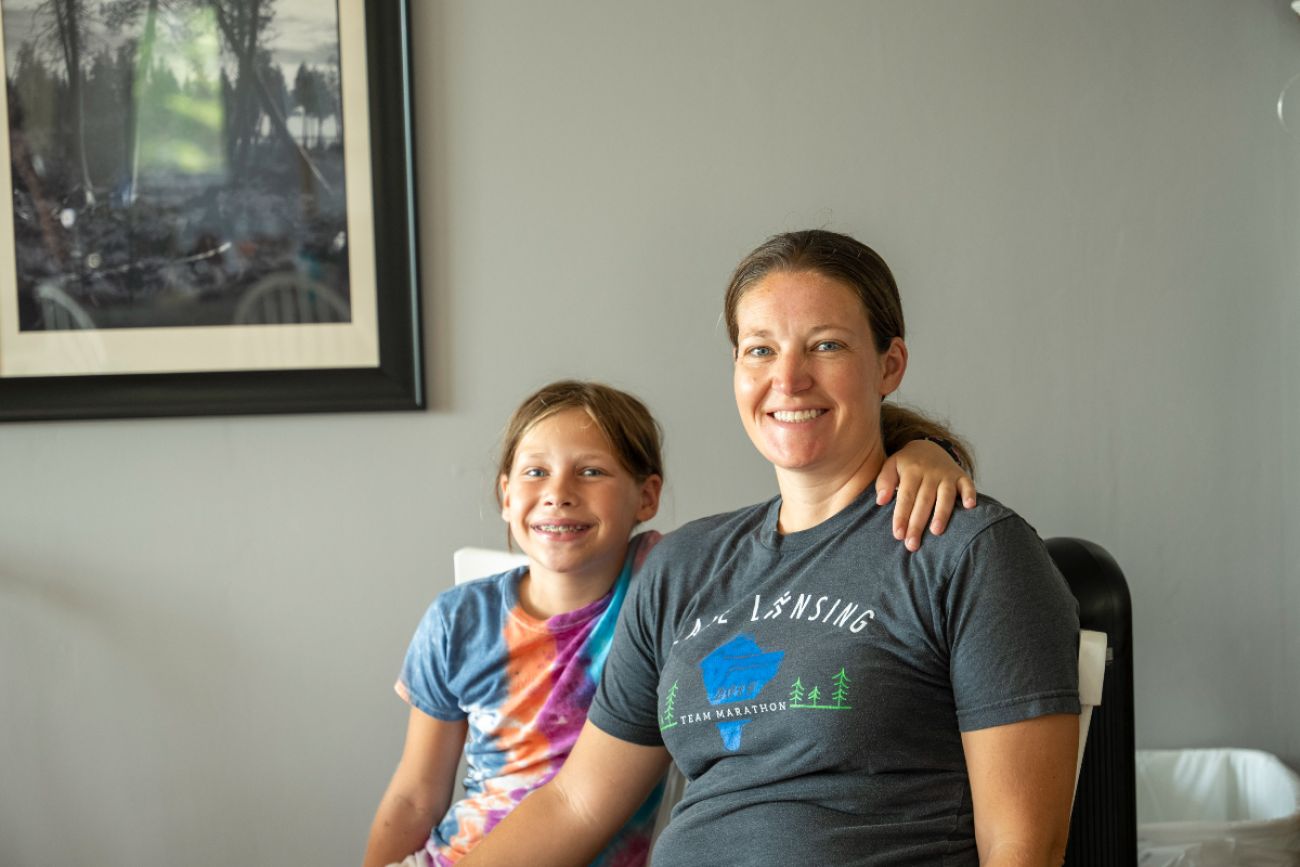 A child and mother posing for a picture