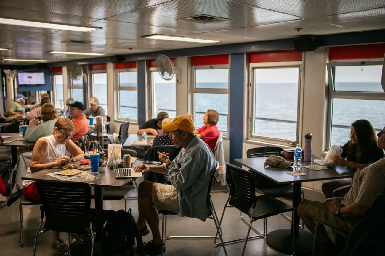 People sitting a tables inside the SS Badger