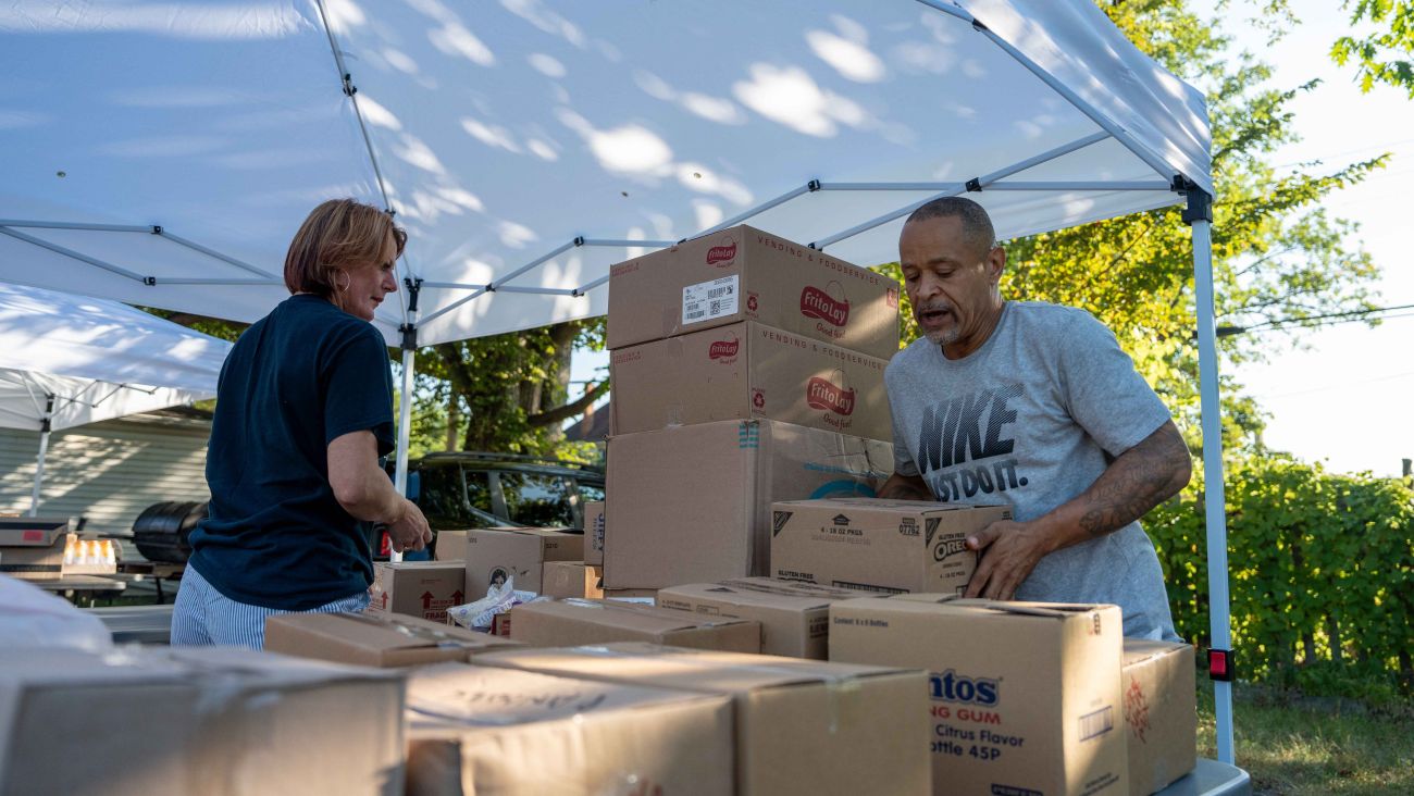 Amy Kukuk and Henry Derrick staking boxes outside