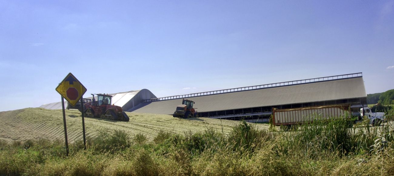 A hilly farm. There's a barn and a tractor
