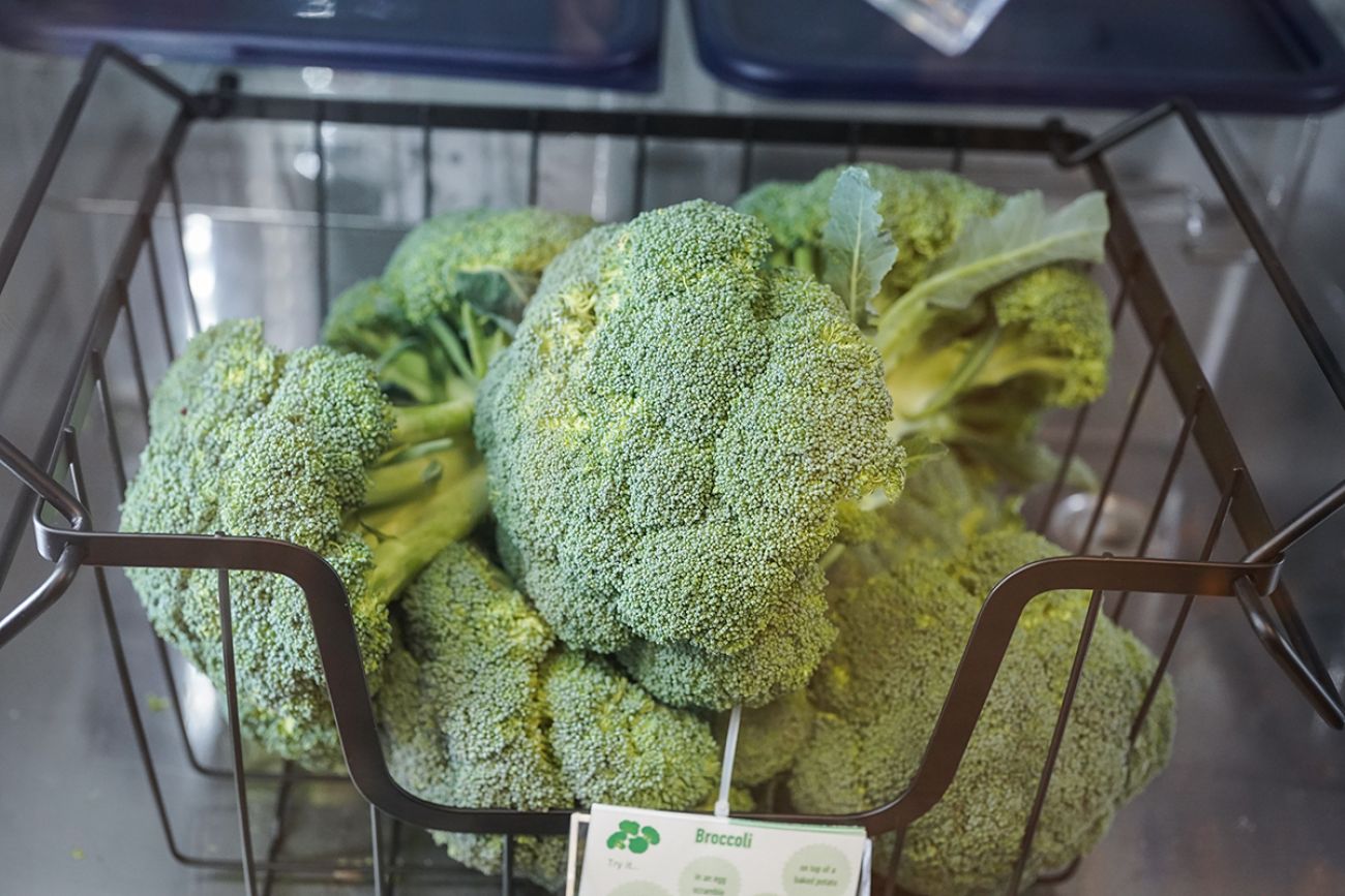 Raw broccoli in a wire basket