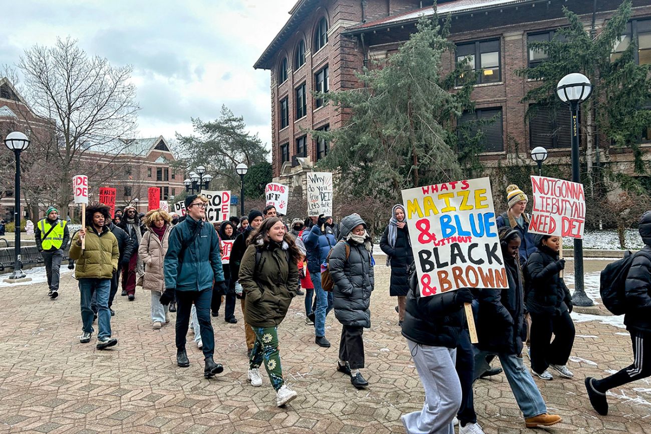 DEI supporters marching and pro-DEI signs