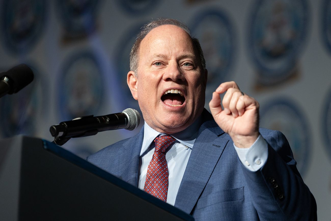 Detroit Mayor Mike Duggan is speaking into a microphone