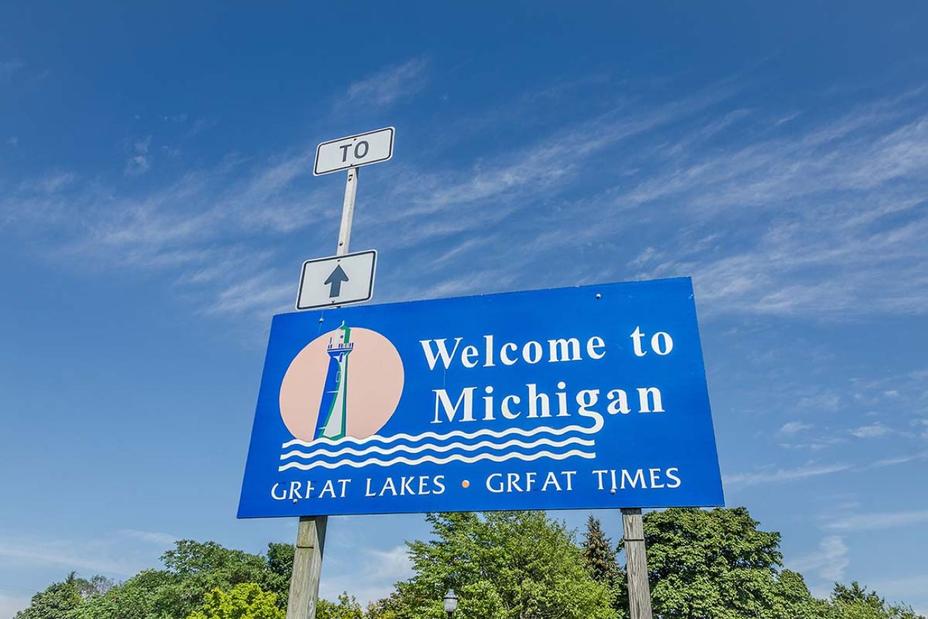 A blue Welcome to Michigan sign