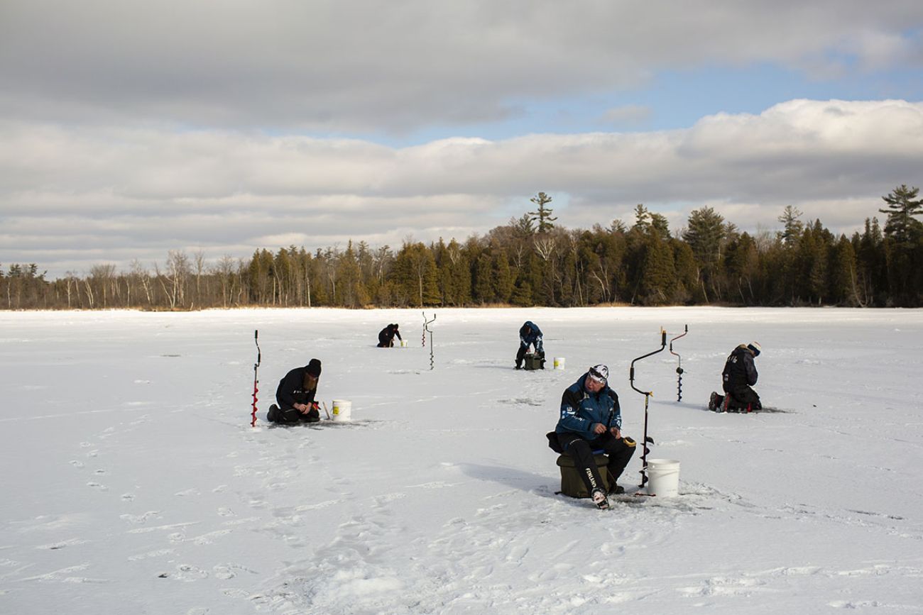 Five anglers on the frozen lake.