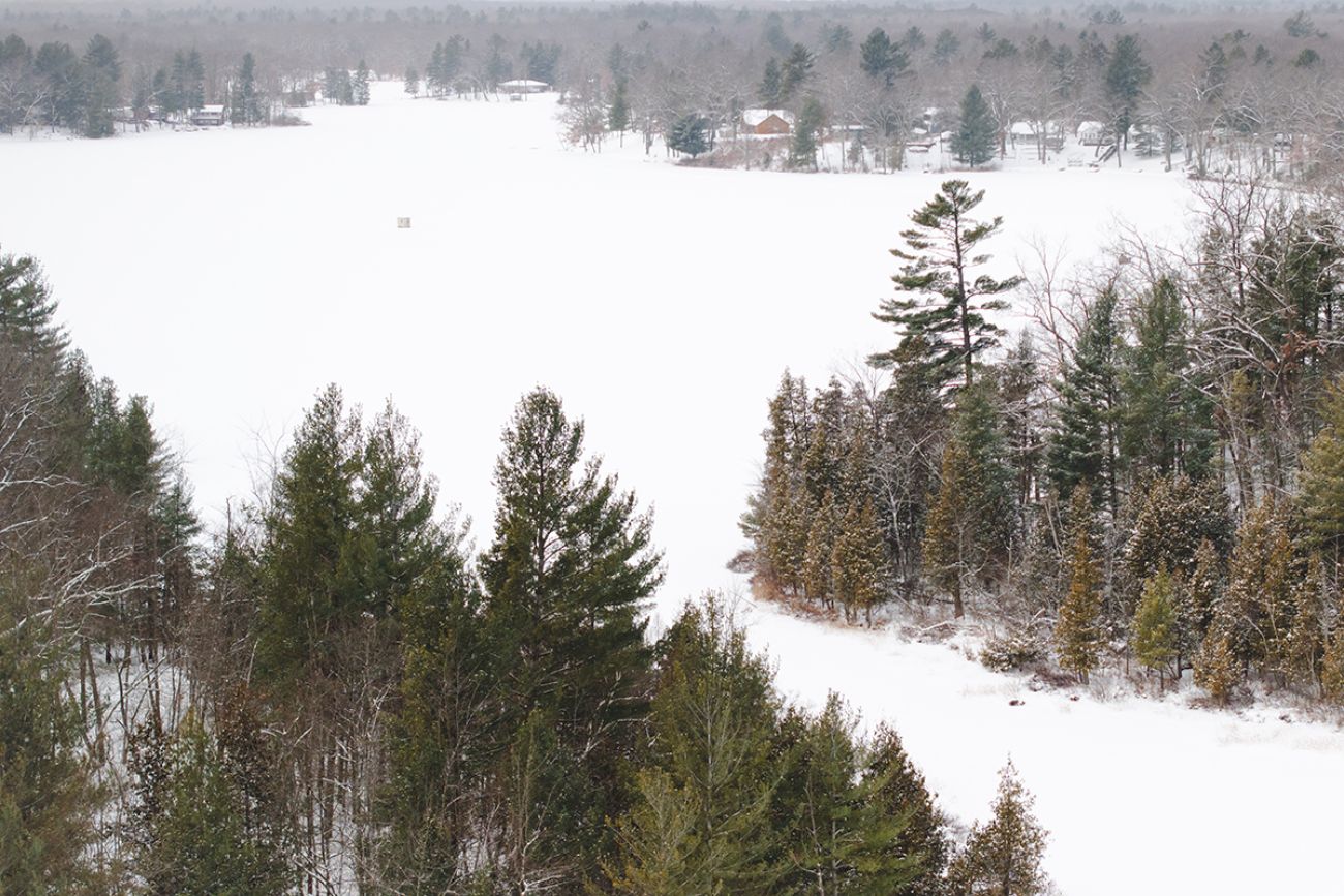 An aerial view of a snowy Woodland Lake in Michigan.