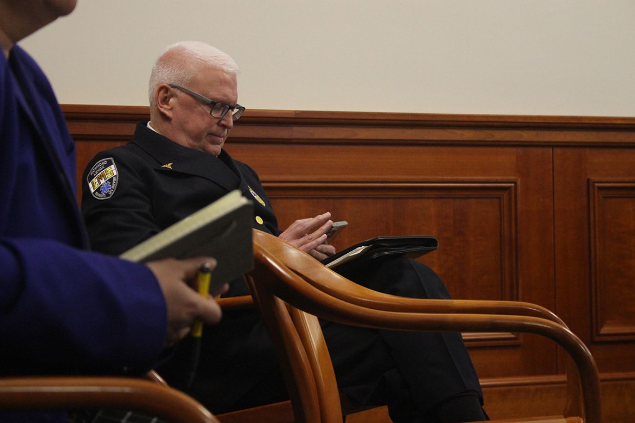Jeff White, in his uniform, sitting in a chair.