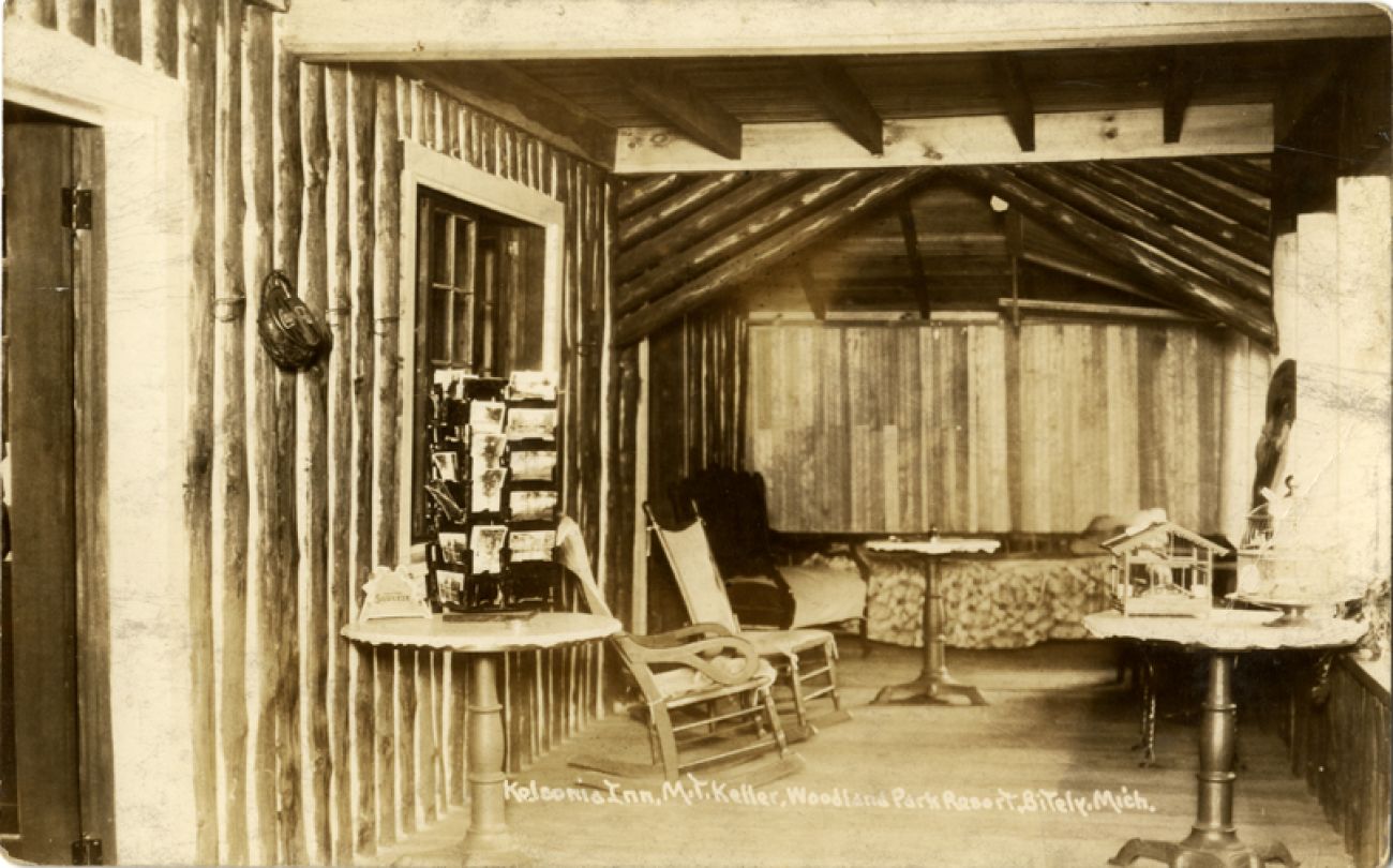 A historic postcard of the Kelsonia Inn. Looks like a small cabin room.