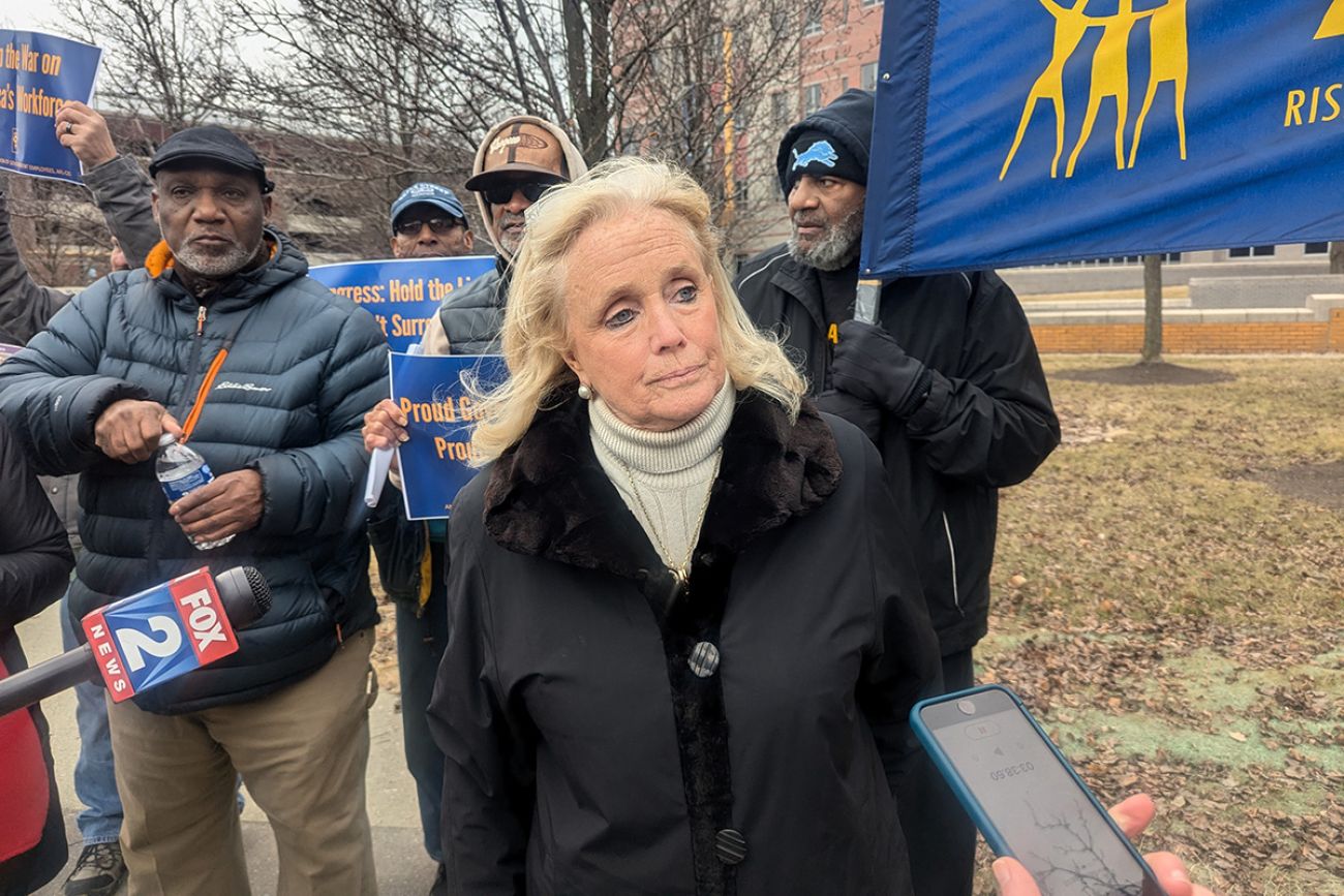 US Rep. Debbie Dingell standing next to protestors.