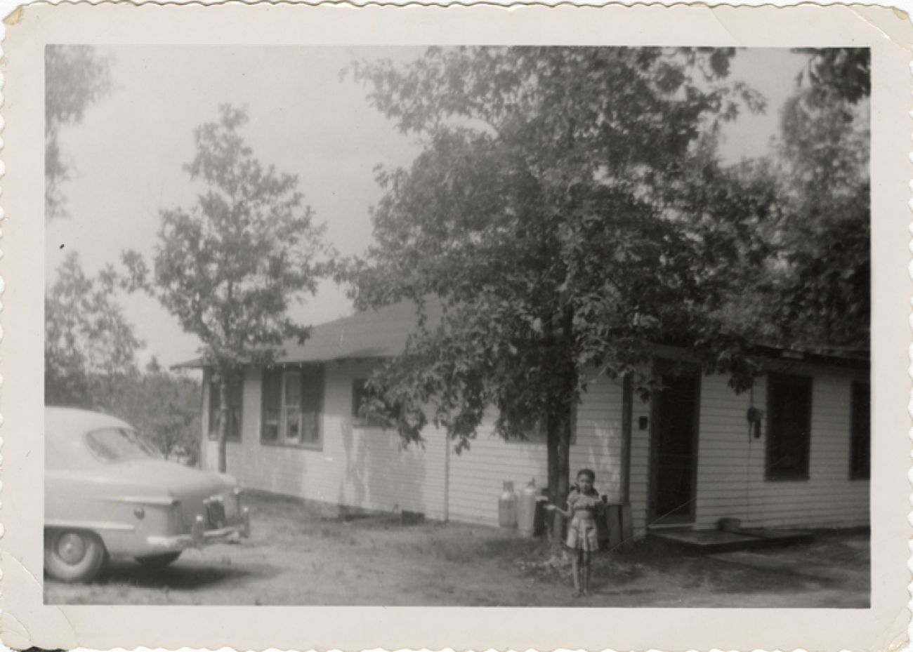 A black and white photo of a little girl in Idlewild.