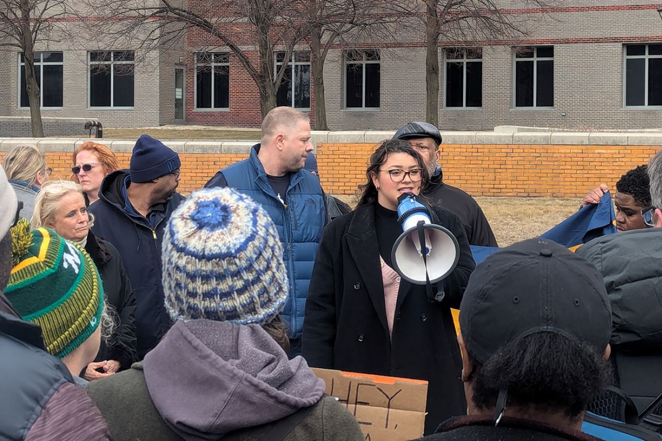 Hailey Kenward speaking into a megaphone in a protest.