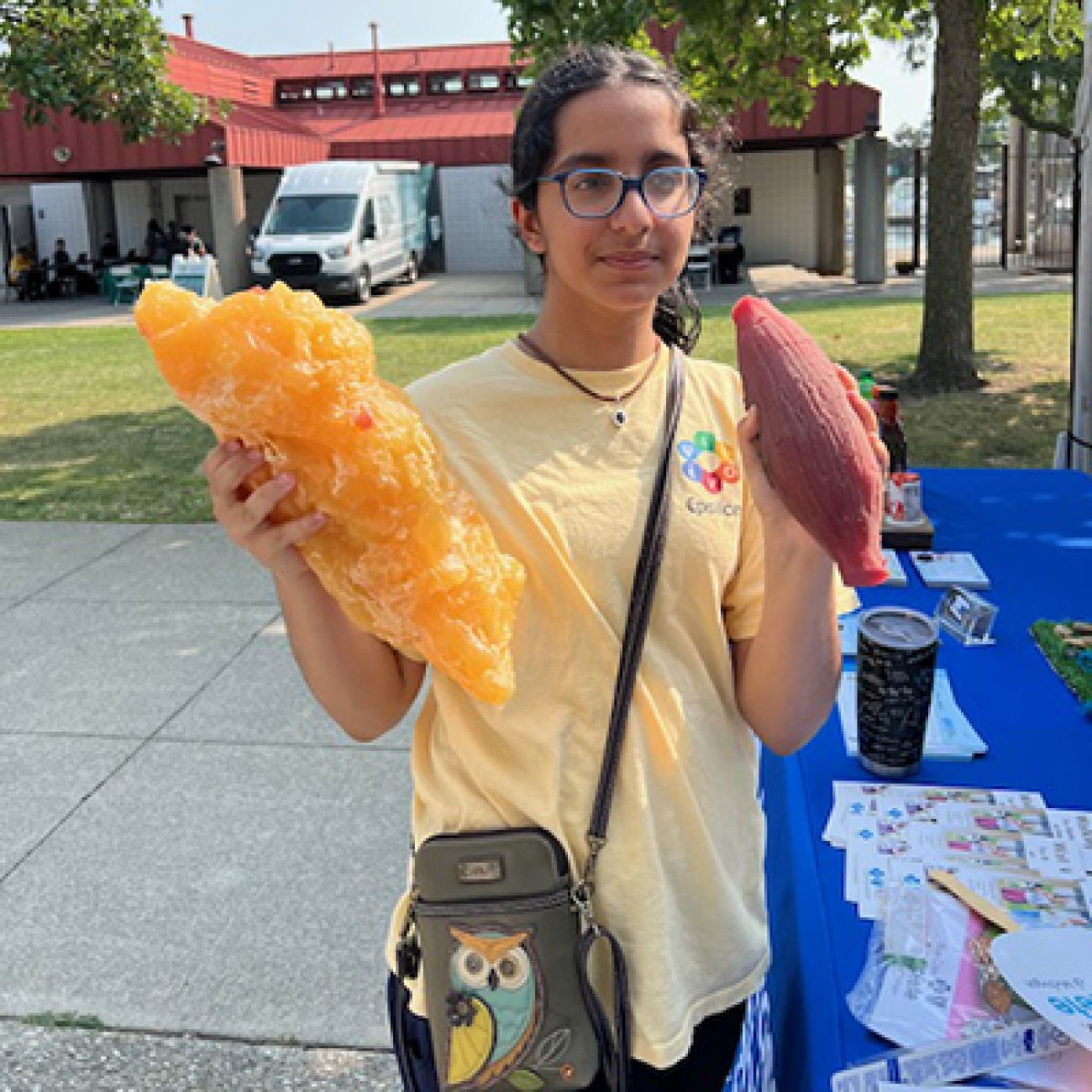 Simran Adnani hold an ear of corn and a blob of fat.