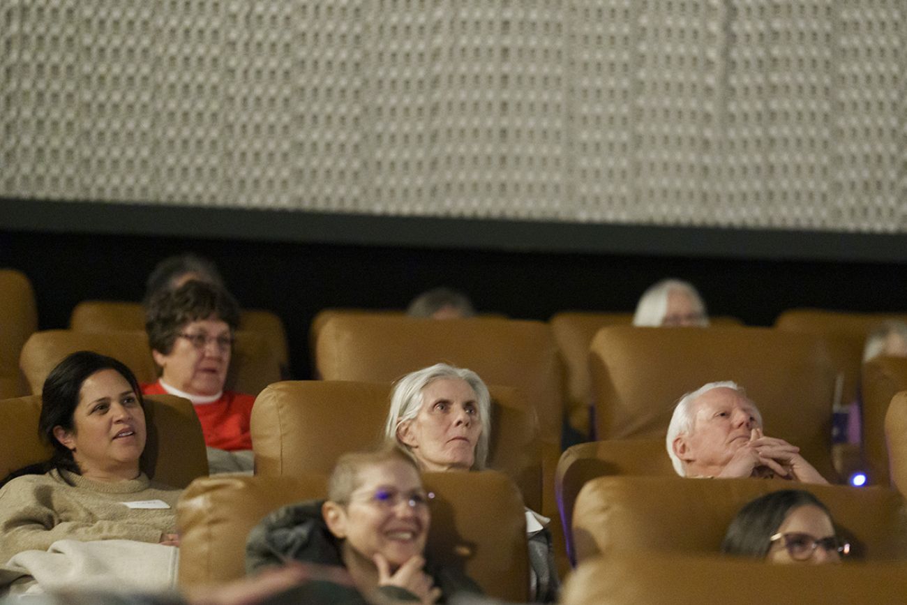 Older people are sitting in a movie theater.