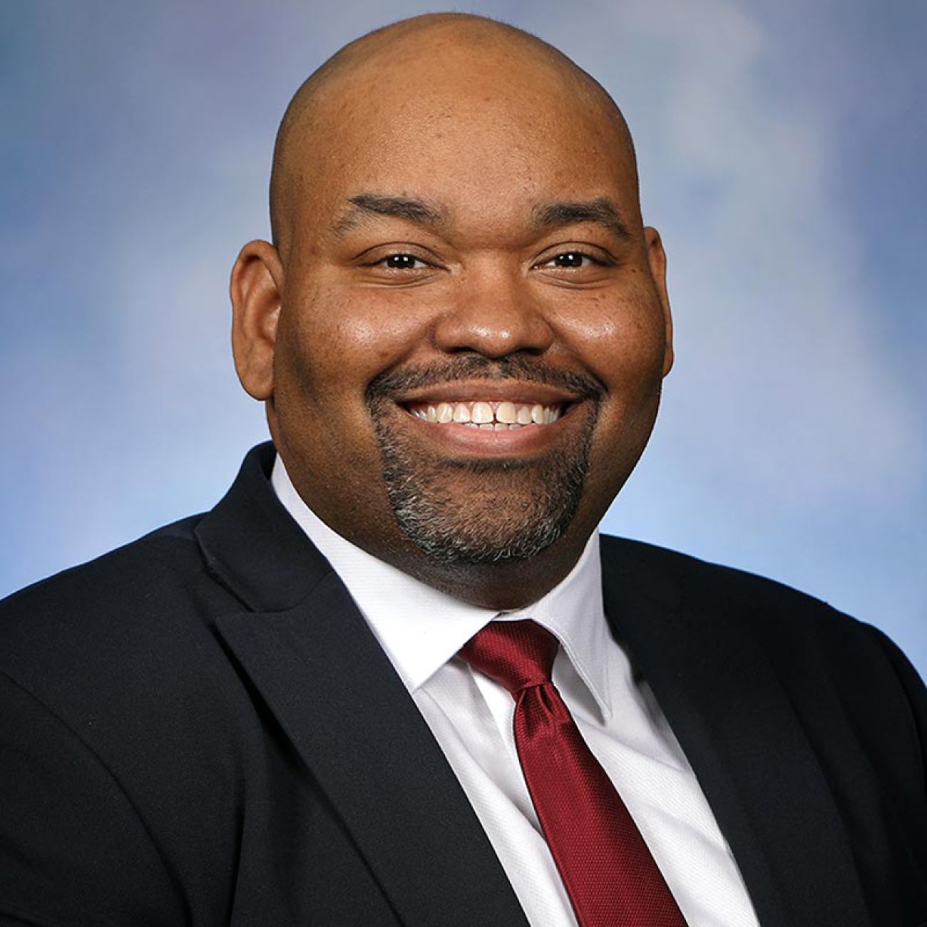 Michigan Rep. Jason Hoskins, D-Southfield, headshot, blue background.