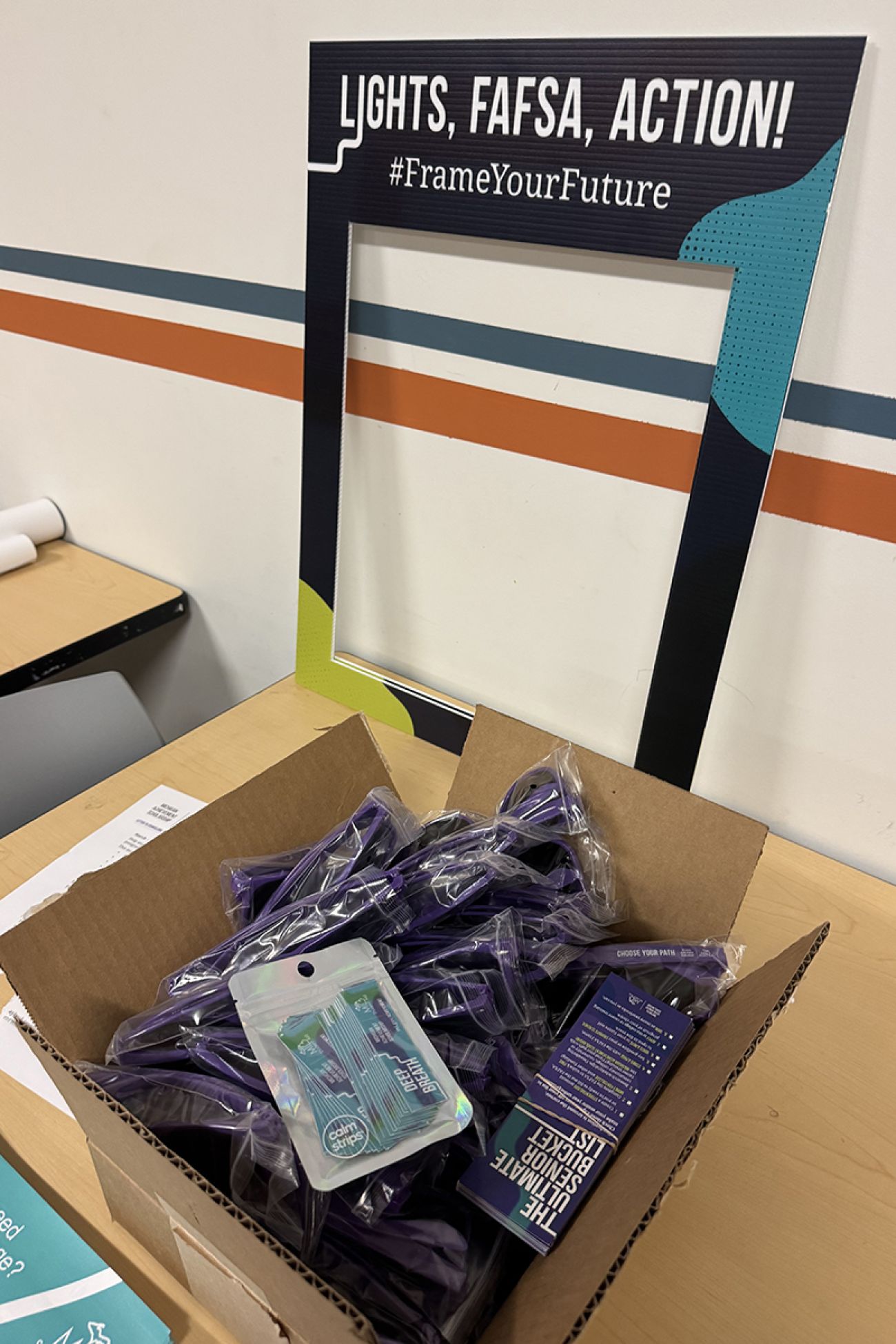 A box of mailers and promotional sunglasses.