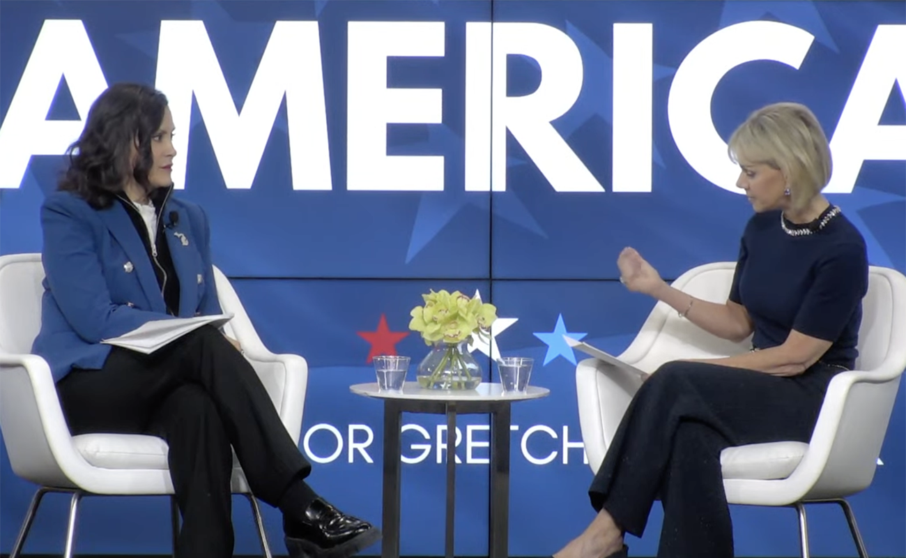 Gov. Gretchen Whitmer talking to former Fox News anchor Gretchen Carlson on a stage.