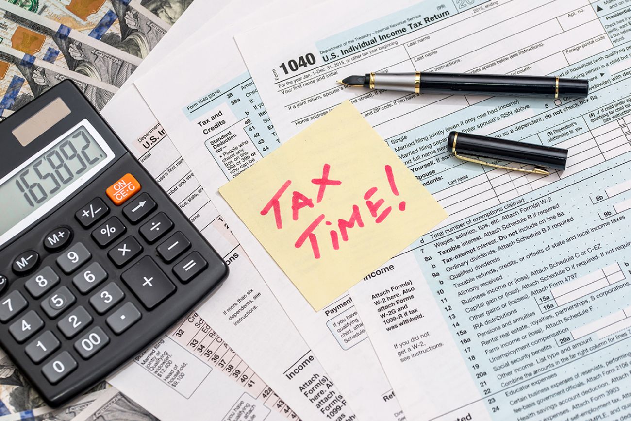 tax form with sticker calculator, money and pen business concept