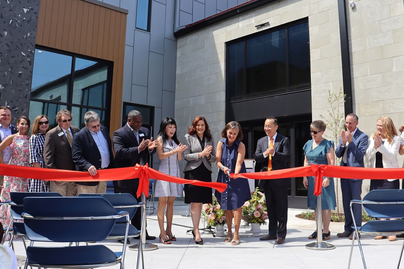 Whitmer at a ribbon cutting ceremony with other officials.