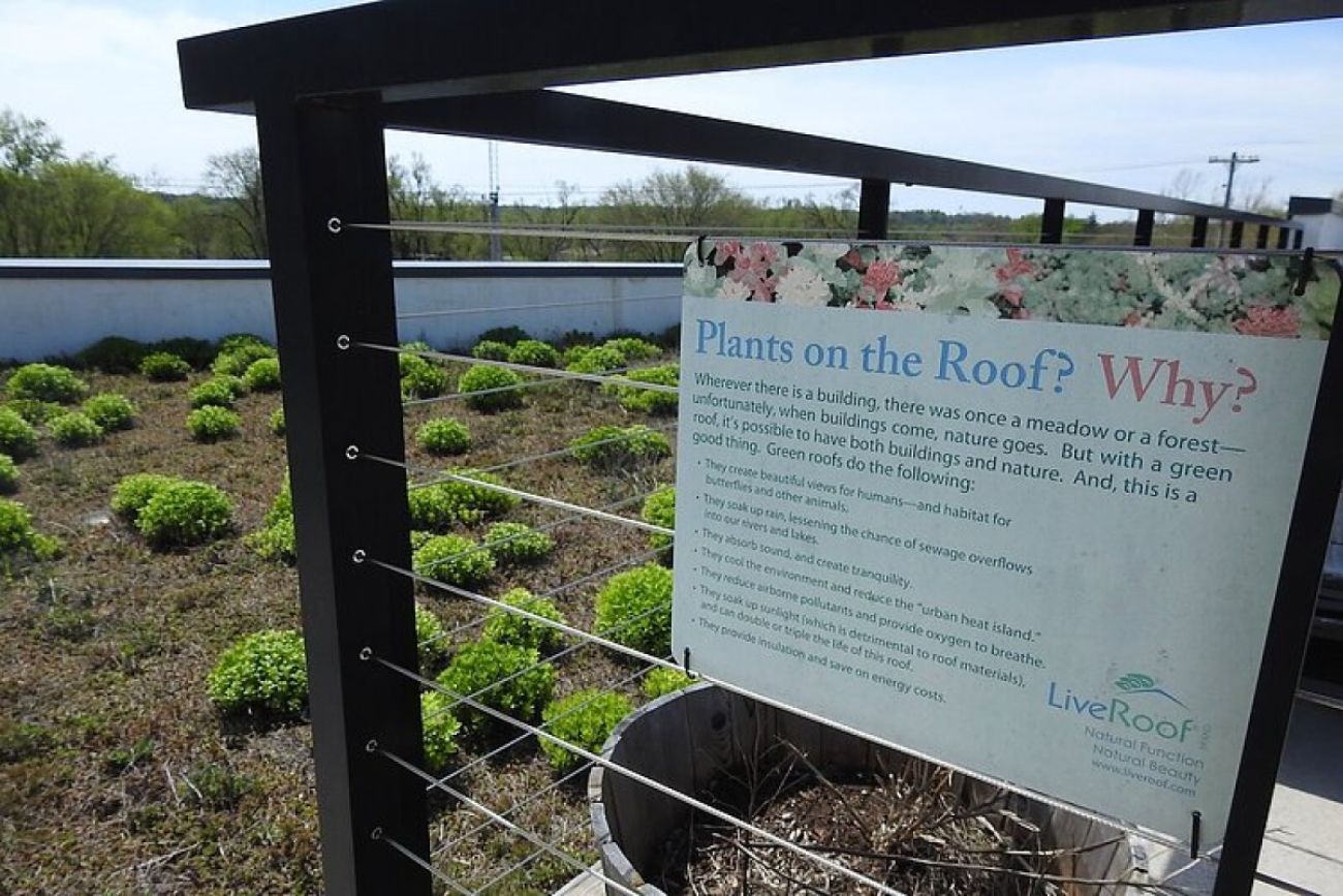 A sign explains the greenery growing on a rooftop