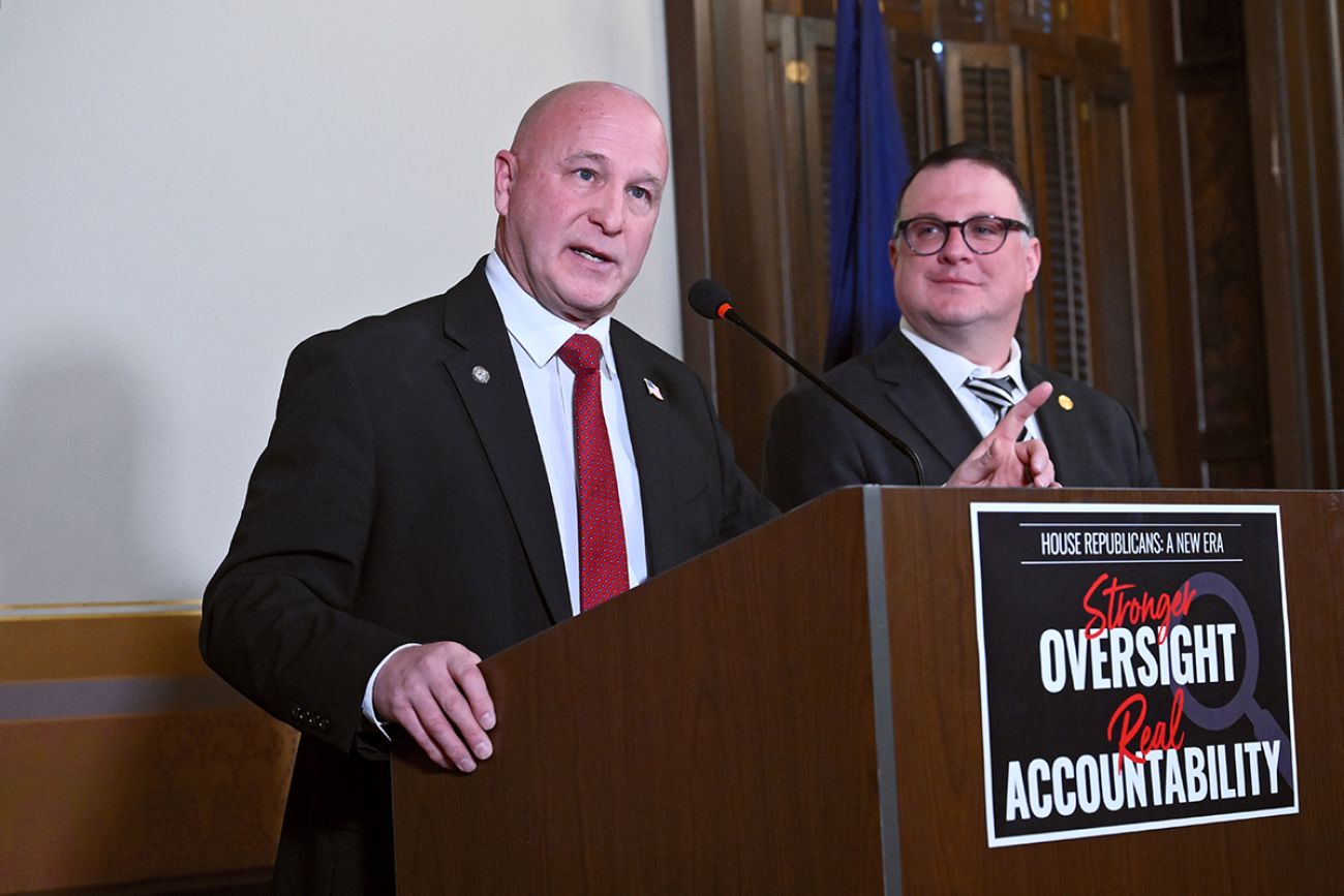 Rep. Jay DeBoyer, a Clay Republican and chair of the House Oversight Committee, speaks into a microphone. House Speaker Matt Hall is standing next to him.