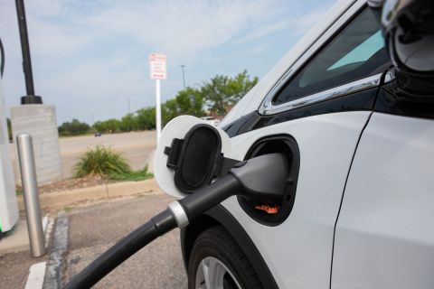A white Chevy Bolt being charged 