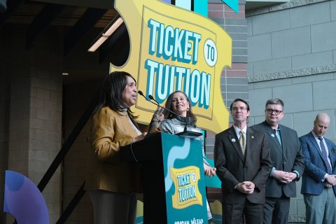 Michigan officials at a press conference for the Ticket to Tuition competition.