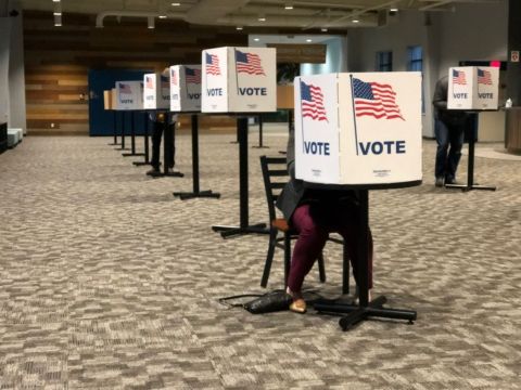 People voting at booths. 