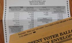 Michigan absentee ballot, next to it is a brown envelope 