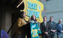 Michigan officials at a press conference for the Ticket to Tuition competition.