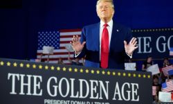 Donald Trump waves to a crowd at Macomb Community College during a rally