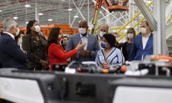 Gov. Gretchen Whitmer at the Ford Motor Co. plant in Dearborn, Michigan. People are wearing maps.