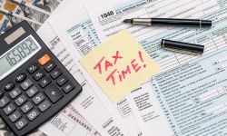 tax form with sticker calculator, money and pen business concept