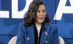 Gov. Gretchen Whitmer, blue background behind her.