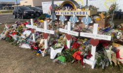 Names of students killed in Oxford High School shooting are displayed on white crosses amid a memorial 